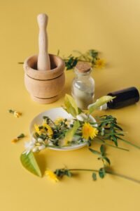 flowers and leaves near mortar and pestle